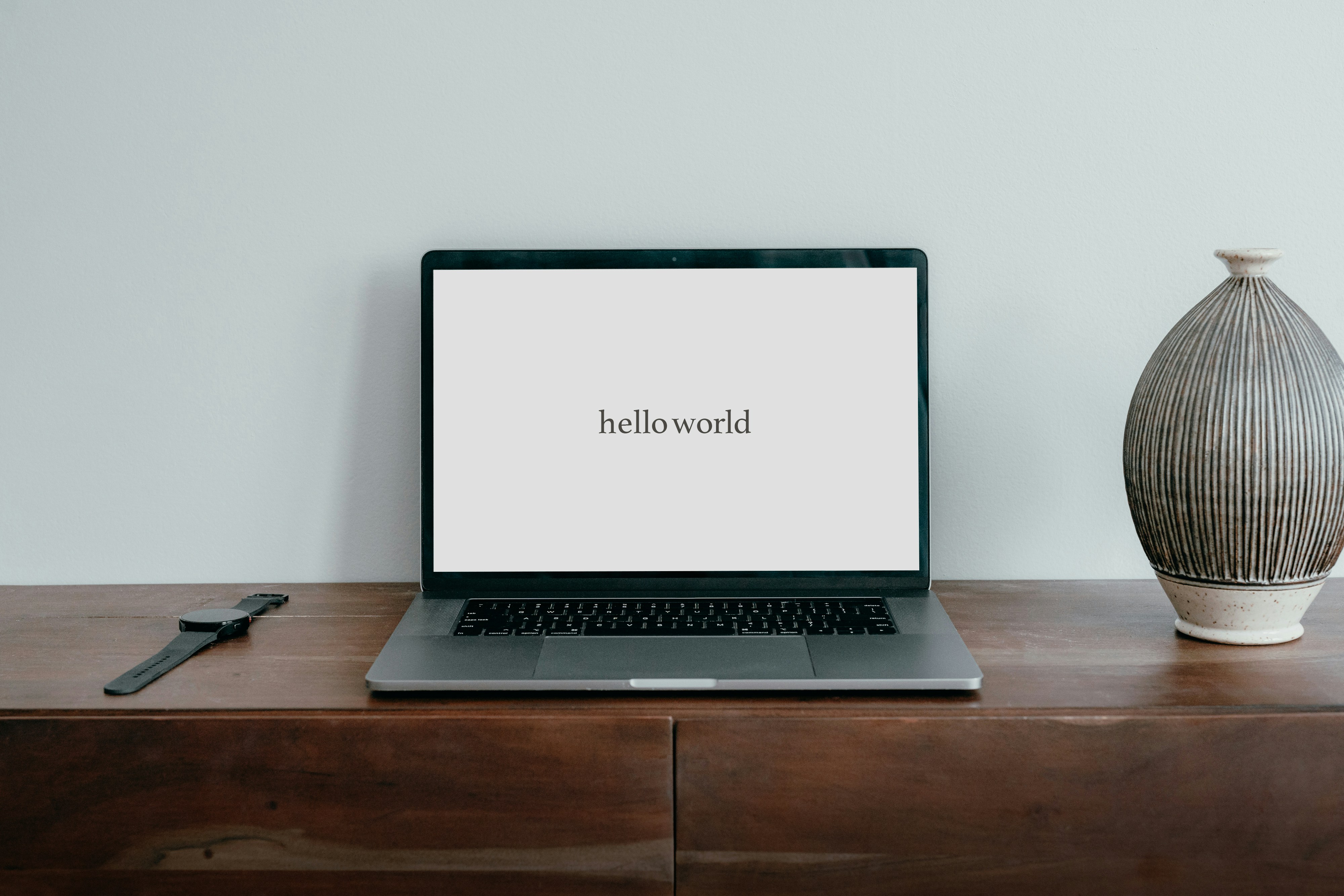 A laptop that says the words hello world in the middle